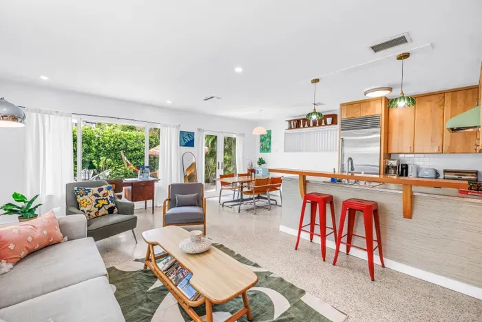 Bright open-plan living with garden views, breakfast bar, and stylish seating