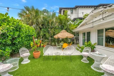 Tropical private courtyard with lounge seating and cozy string lights
