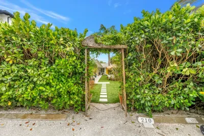 Private tropical garden entry with charming path to outdoor retreat