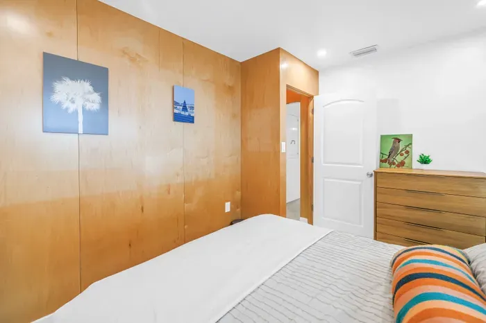 Cozy minimalist bedroom with warm wood accents and bright, modern style