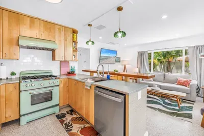 Bright open kitchen with vintage charm and a cozy tropical living area