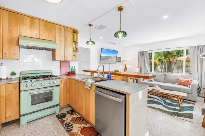 Bright open kitchen with vintage charm and a cozy tropical living area