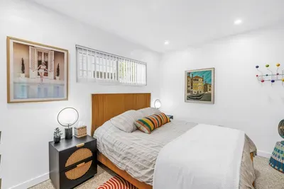 Bright modern bedroom with stylish decor and a cozy, inviting feel