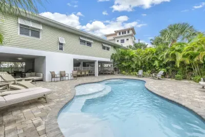 Outdoor Oasis: Dive into relaxation by the sparkling pool surrounded by lush tropical greenery!