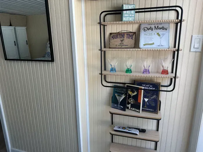 Playful cocktail nook with glassware & mixology books—cheers-ready!