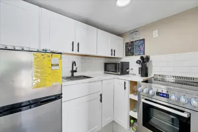 Bright, modern kitchenette with full oven, fridge & essentials