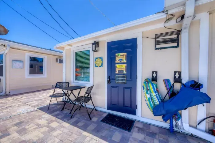 Sunny cottage entry with patio set, keyless entry & free beach gear