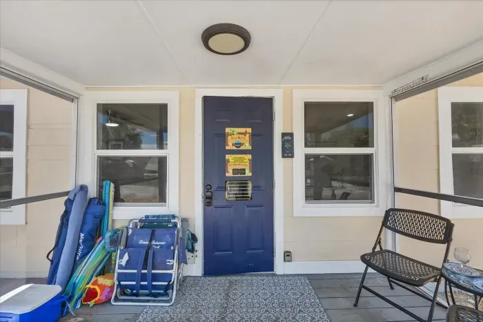 Screened entry with beach gear, seating, and smart lock convenience