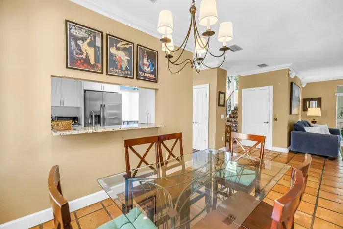 Dining Area: Enjoy meals under elegant lighting with vintage flair and lovely tile floors!