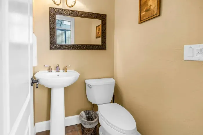 Half Bath: Bright and inviting space with elegant decor and stylish fixtures for your comfort!