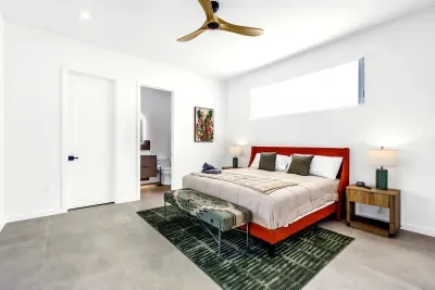 Bright modern bedroom with ensuite access, stylish decor, and airy design