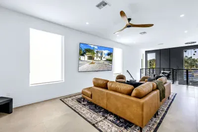 Bright modern loft lounge with leather seating and large TV