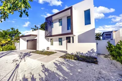 Stylish modern home with sleek design, garage, and sunny curb appeal