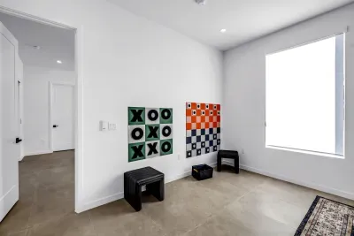 Bright bonus room with natural light and fun oversized wall games