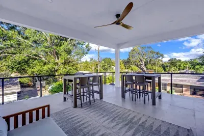 Spacious covered terrace with outdoor dining and peaceful treetop views