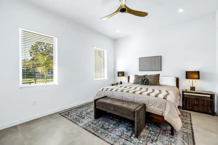 Bright modern bedroom with natural light, stylish decor, and serene views