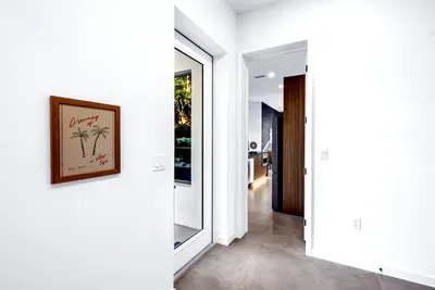 Bright modern entry with natural light and sleek kitchen access