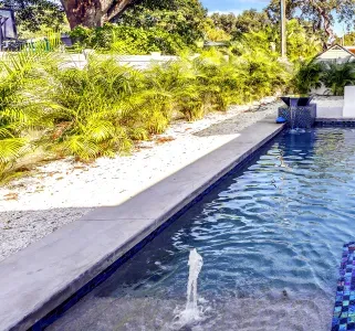 Private tropical pool with serene water features and lush resort-style landscaping