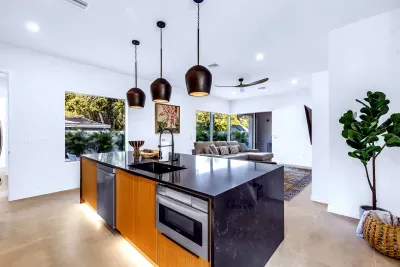 Bright open-plan kitchen with waterfall island and garden views