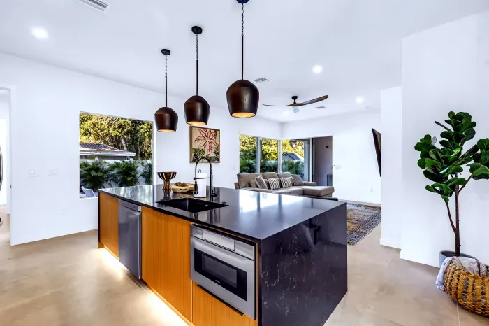 Bright open-plan kitchen with waterfall island and garden views