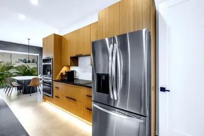 Modern designer kitchen with stainless appliances and open dining area