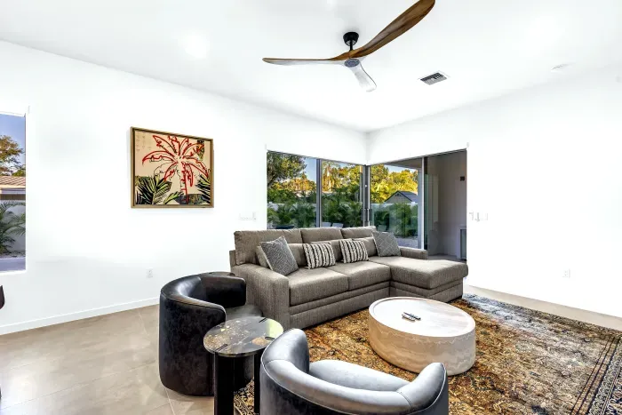 Bright modern living room with corner windows and cozy seating