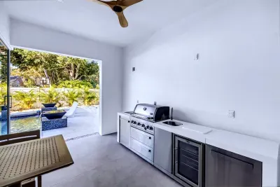Modern poolside outdoor kitchen with seamless indoor-outdoor flow