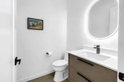 Bright modern bathroom with sleek vanity and illuminated mirror