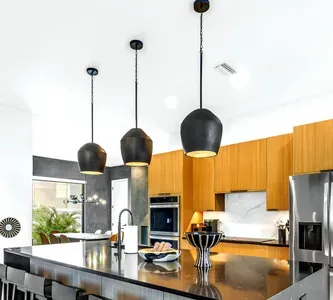 Bright designer kitchen with waterfall island and stylish pendant lighting