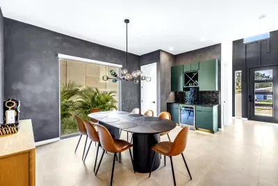 Modern dining room with designer lighting and chic built-in bar