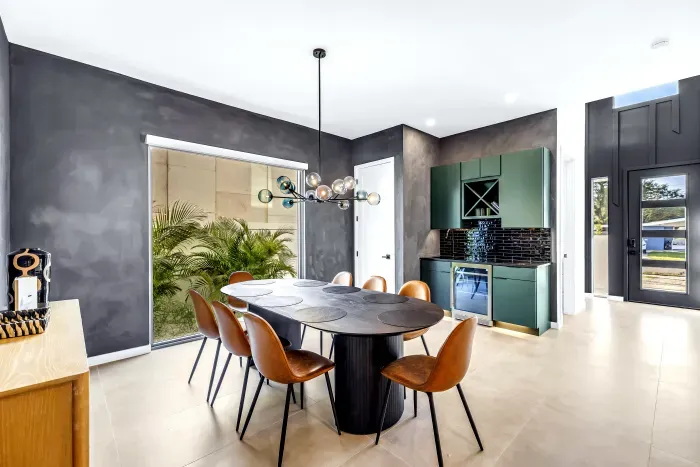 Modern dining room with designer lighting and chic built-in bar