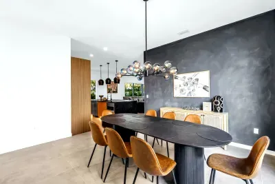 Modern designer dining room with statement lighting and open-concept flow