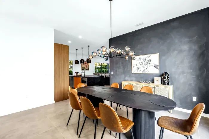 Modern designer dining room with statement lighting and open-concept flow