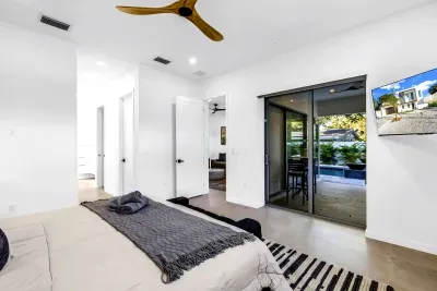 Bright modern bedroom with patio access and pool views