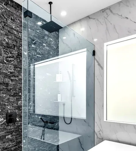 Spa-like marble shower with rainfall head and sleek glass enclosure