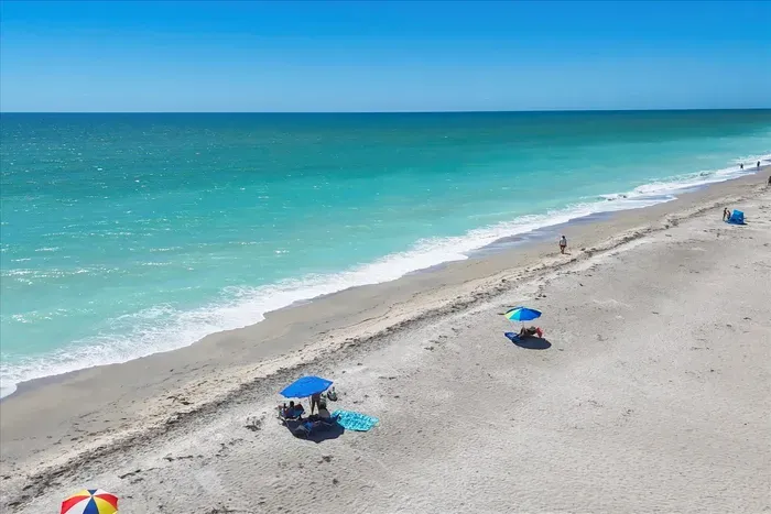 Uncrowded sugar-sand beach with turquoise water—steps from your stay
