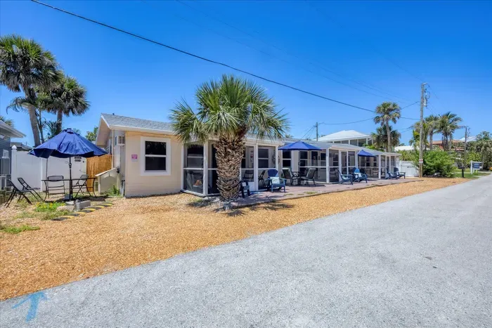 Cozy coastal cottages with screened porches, patio seating, and palms