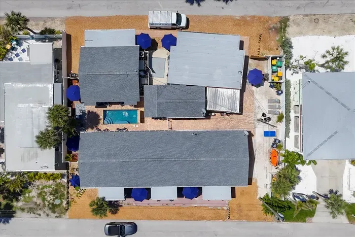 Coastal cottage compound with pool, patios, and steps from the beach