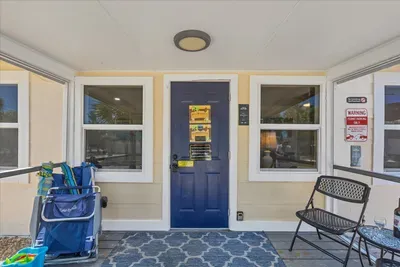 Screened entry with beach gear, seating, and keyless access.