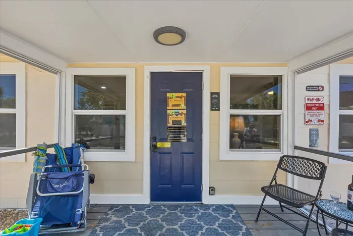 Screened entry with beach gear, seating, and keyless access.