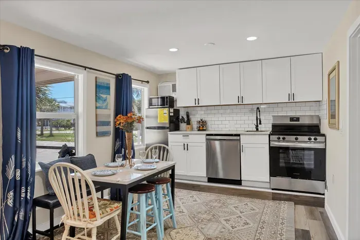 Sunny kitchen with stainless suite, gas range, and cozy dining for four.