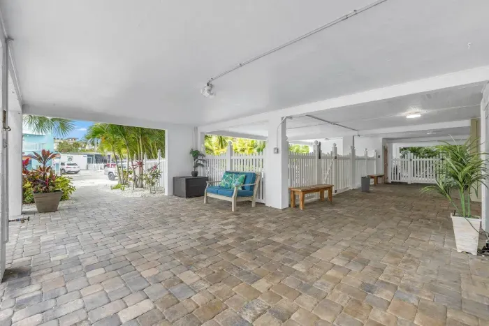 Welcoming Outdoor Space: Relax in style on the patio amid tropical landscaping and paver stones!