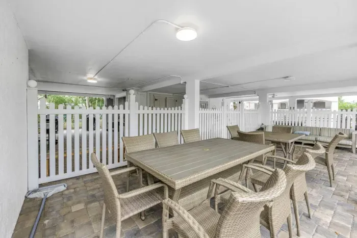 Outdoor Dining Space: Enjoy delightful al fresco meals in this charming shaded retreat!
