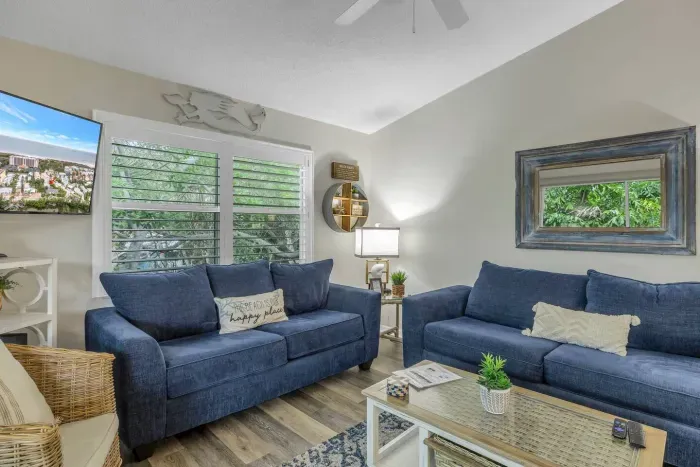 Living Room: Sunlit space with plush seating and views of lush greenery—perfect for relaxation!