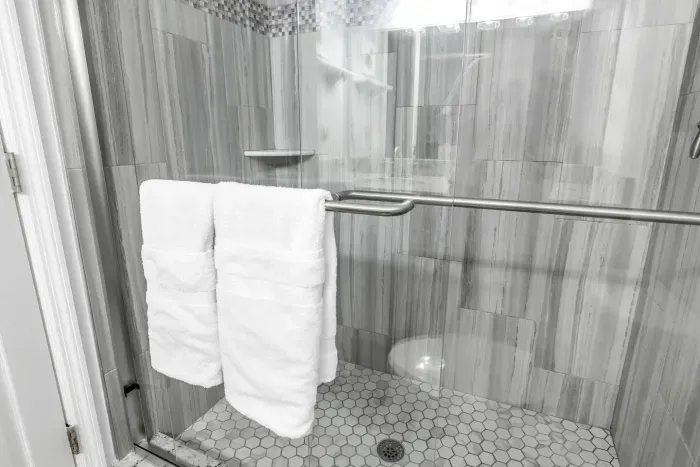 Bathroom Oasis: Refresh in a sleek, modern shower adorned with elegant finishes and plush towels.
