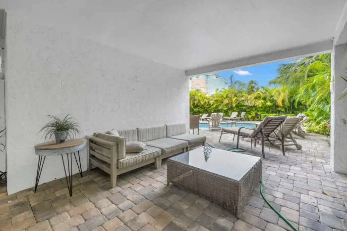 Outdoor Lounge: Unwind in style on a shaded patio, steps from the sparkling pool!