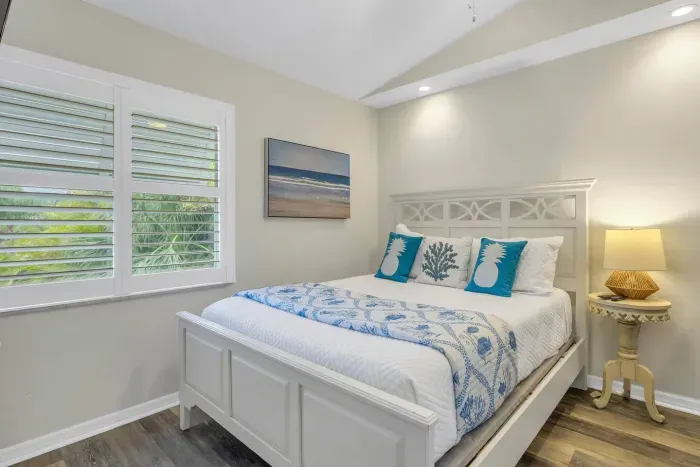 Charming Bedroom: Relax in this bright retreat with king bed, beachy decor, and lush views!