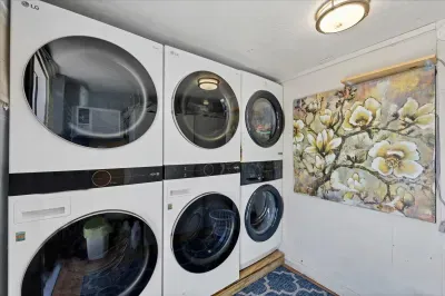 Three LG washer/dryer pairs in a bright, stylish laundry room—easy stays.