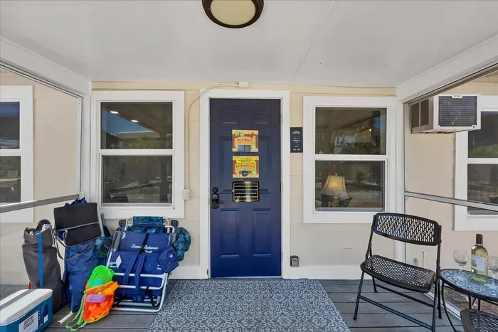 Screened porch with beach gear, bistro seating & keypad entry