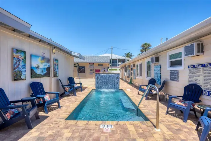 Sunny courtyard with 3‑ft plunge pool, waterfall and Adirondack seating